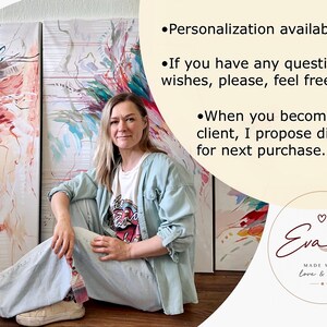 May include: An artist sits in front of three abstract paintings with red, blue, and green brushstrokes. The artist wears a light blue jacket, white t-shirt, and light blue jeans. Text on the image says "Personalization available."