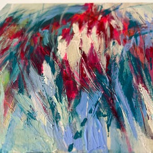 May include: Abstract painting with a textured surface. The artwork features bold brushstrokes in shades of red, teal, blue, and white. The composition has a dynamic, energetic feel, with the colors blending and overlapping to create depth and movement.
