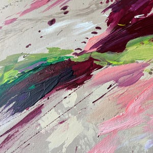 May include: Abstract painting with a palette of pink, green, purple, and white brushstrokes. The artwork features a textured canvas with dynamic, diagonal strokes and splatters, creating a sense of movement and depth. The colors blend and overlap.