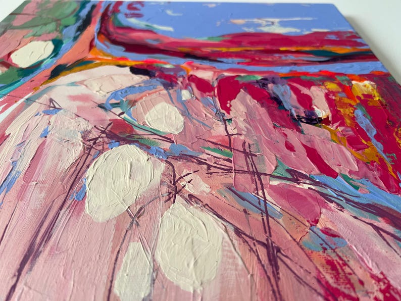 May include: Abstract painting with thick brushstrokes in shades of pink, red, blue, and white. The artwork features large white shapes and textured paint, creating a dynamic and colorful composition. The painting is on a square canvas.