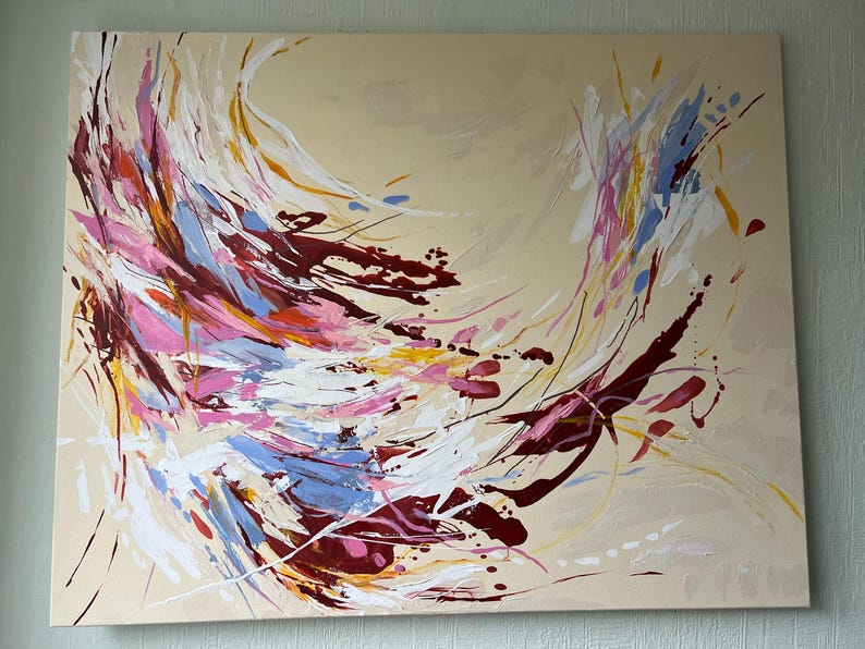 May include: Abstract painting on canvas featuring a swirling composition of colors. The artwork showcases dynamic brushstrokes in shades of burgundy, pink, blue, yellow, and white against a beige background. The piece evokes a sense of movement and energy.