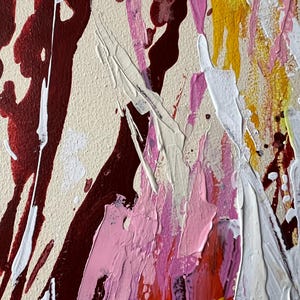 May include: Abstract painting with a beige background and bold strokes of burgundy, white, pink, yellow, and orange. The artwork features a textured surface with splatters and drips, creating a dynamic and expressive composition.