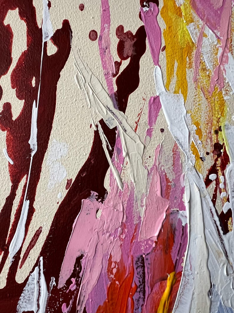 May include: Abstract painting with a beige background and bold strokes of burgundy, white, pink, yellow, and orange. The artwork features a textured surface with splatters and drips, creating a dynamic and expressive composition.