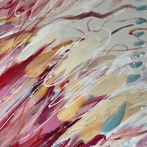 May include: Abstract painting with a palette of pink, red, yellow, and blue hues. The artwork features dynamic brushstrokes and white linear accents, creating a sense of movement and texture. The composition is a close-up view of the painted canvas.