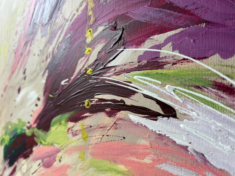 May include: Close-up of an abstract painting with thick brushstrokes. The artwork features a palette of colors including deep purple, pink, green, and white, applied on a beige canvas. The texture is rich and the style is expressive.