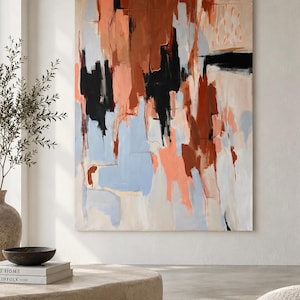 May include: A large rectangular abstract painting featuring vertical brushstrokes in shades of terracotta, burnt orange, black, light blue, and cream. The composition displays layered paint textures with bold, dark vertical shapes contrasting against softer, lighter pastel tones across the canvas surface.