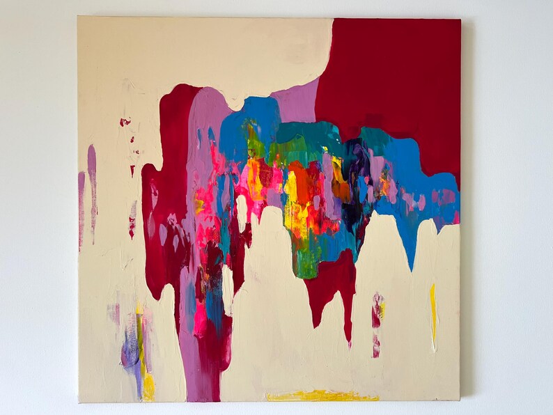 May include: Abstract canvas painting with a cream backdrop and vibrant strokes of red, purple, blue, yellow, and pink. The artwork showcases a blend of textures and colours, producing a dynamic visual impact.