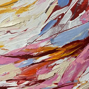 May include: Abstract painting with thick brushstrokes in shades of red, white, pink, blue, orange, and gold. The textured surface creates a dynamic and expressive artwork, evoking a sense of movement and depth. The artwork is a close-up of the painting.