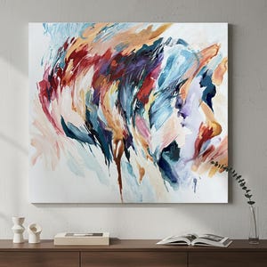 May include: Abstract art painting with a vibrant display of colors. The artwork features brushstrokes in shades of red, blue, orange, and purple, creating a dynamic and expressive composition. The painting is displayed on a white canvas.