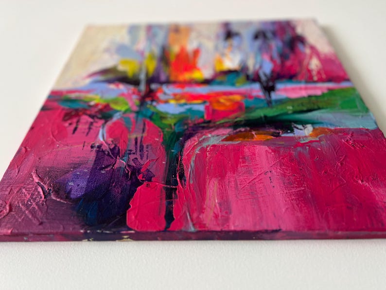 May include: Abstract painting with thick brushstrokes in shades of pink, purple, green, and blue. The artwork features a textured surface and a vibrant color palette, creating a dynamic and expressive composition. The painting is on a square canvas.