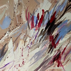 May include: Abstract painting with a beige background and dynamic brushstrokes in white, red, blue, and black. The artwork features a textured surface with splatters and streaks, creating a sense of movement and depth. The style is expressive and modern.