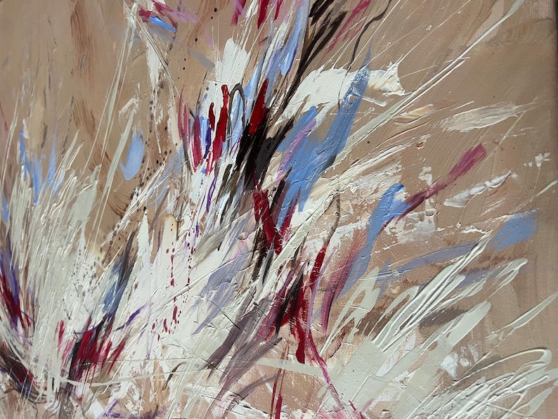 May include: Abstract painting with a beige background and dynamic brushstrokes in white, red, blue, and black. The artwork features a textured surface with splatters and streaks, creating a sense of movement and energy.