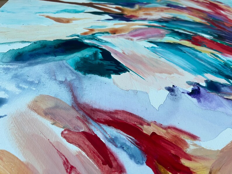 May include: Abstract painting with a close-up view of brushstrokes in shades of red, blue, teal, and peach. The artwork is on a white canvas, with the brushstrokes creating a sense of movement and texture.