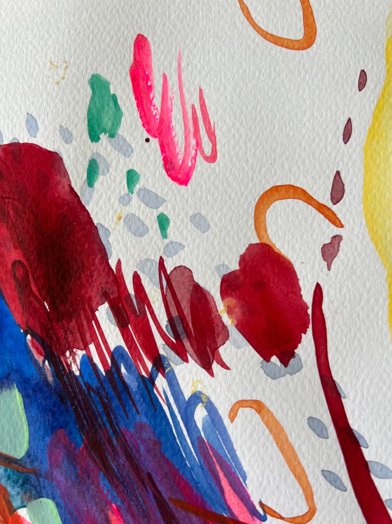 May include: An abstract watercolor painting on textured white paper featuring bold splashes of deep red, vibrant blue, bright yellow, and hot pink. The composition includes thin orange curved lines, small grey dashes, and green paint spots.