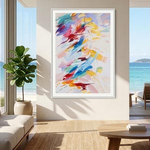 May include: A vertical rectangular framed wall art piece featuring an abstract composition of vibrant brushstrokes in shades of red, blue, yellow, and soft pink against a white background, displayed in a thin white frame on a neutral wall.