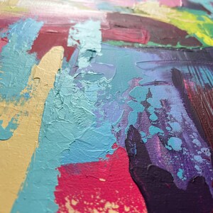 May include: Abstract painting with thick brushstrokes in shades of yellow, teal, pink, purple, and green. The textured surface shows the layering of paint, creating a dynamic and colorful artwork. The artwork is a close-up view of the painting.