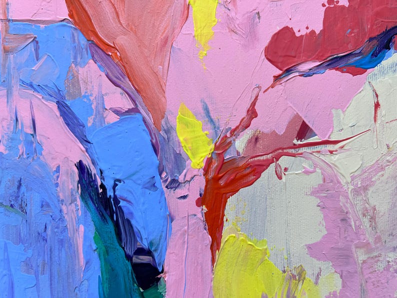 May include: Abstract oil painting in pink, blue, red, and yellow. The thick brushstrokes create a textured surface. The artwork has a dynamic composition with bold colour contrasts and expressive marks.
