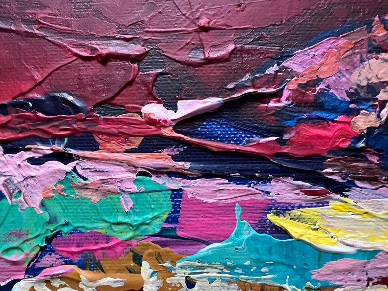 May include: Close-up of an abstract painting with thick brushstrokes. The artwork features a palette of colors including deep reds, blues, pinks, greens, and yellows. The texture is heavily layered, creating a three-dimensional effect.