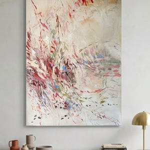 May include: A large rectangular canvas painting featuring an abstract composition with a cream-colored background. The artwork displays dynamic, sweeping brushstrokes in shades of deep red, burgundy, soft pink, sage green, and touches of bright blue.