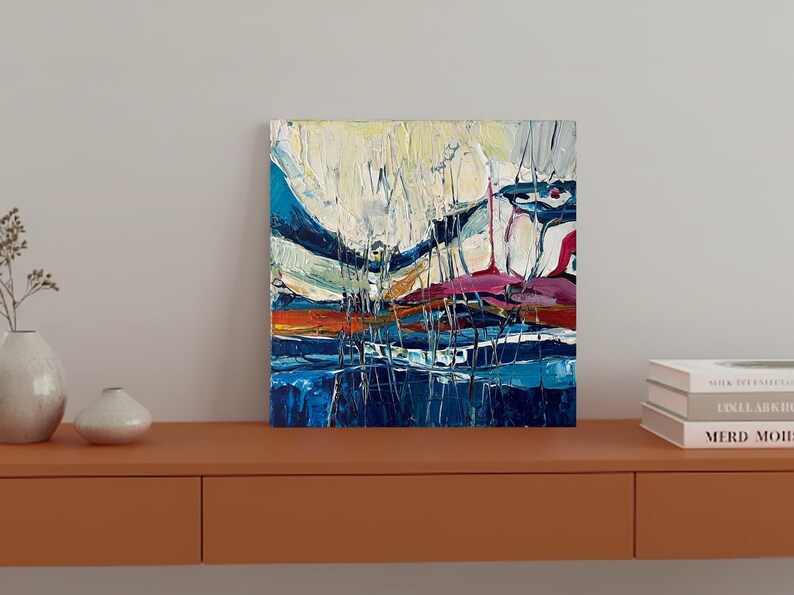 May include: Abstract oil painting on canvas with a textured, impasto style. The artwork features a vibrant color palette of blues, white, orange, and pink. The composition includes vertical and horizontal brushstrokes, creating a dynamic landscape.