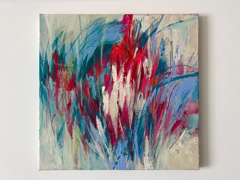 May include: Abstract painting with a textured surface. The artwork features bold brushstrokes in shades of red, teal, and blue, with hints of white and cream. The composition evokes a sense of movement and energy, with a focus on color and texture.
