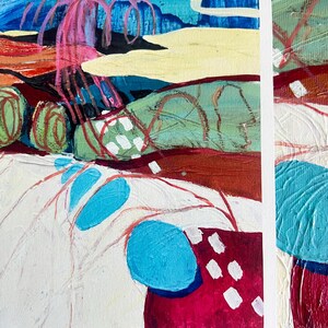 May include: An abstract painting featuring layered textures and bold colours including bright blue, deep magenta, sage green, and cream. The composition displays organic shapes, scribbled red lines, and white rectangular marks on a canvas surface.