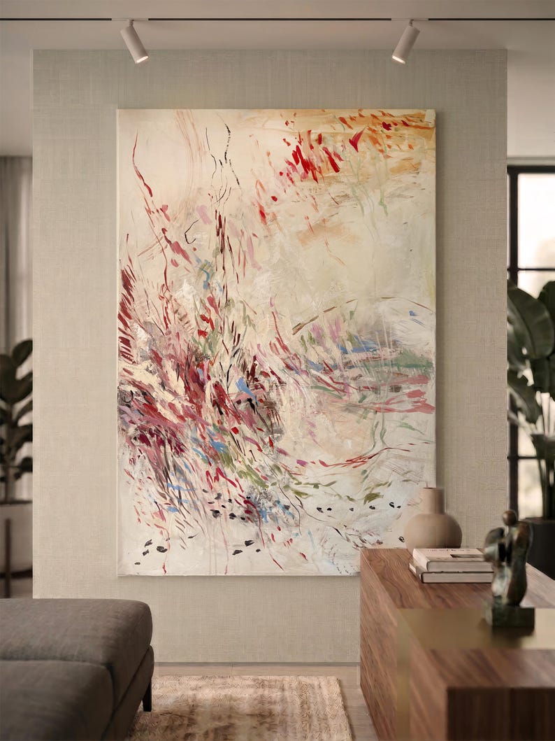 May include: A large rectangular canvas painting featuring an abstract composition with a cream-colored background. The artwork displays energetic, gestural brushstrokes in shades of deep red, burgundy, soft pink, muted green, and blue.