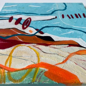 May include: Abstract painting on canvas with a textured surface. The artwork features a landscape with blue, orange, red, and yellow brushstrokes. The composition includes curved lines and shapes, suggesting a stylized view of nature.