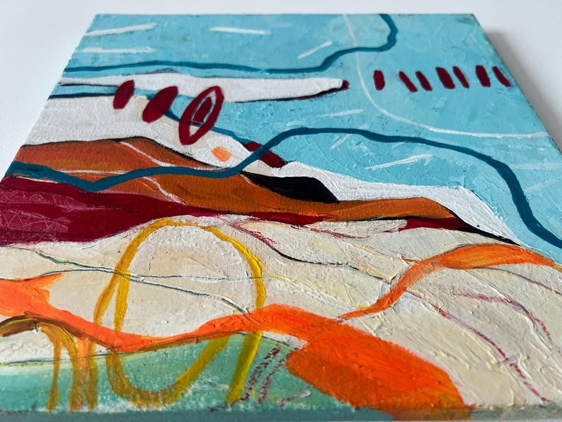 May include: Abstract painting on canvas with a textured surface. The artwork features a landscape with blue, orange, red, and yellow brushstrokes. The composition includes curved lines and shapes, suggesting a stylized view of nature.