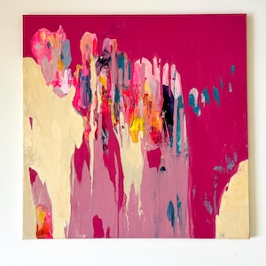 May include: Abstract painting on canvas with a vibrant fuchsia background. The artwork features layered brushstrokes in shades of pink, yellow, teal, and cream, creating a dynamic and colorful composition. The painting is mounted on a square canvas.