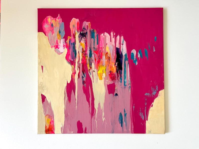 May include: Abstract painting on canvas with a vibrant fuchsia background. The artwork features layered brushstrokes in shades of pink, yellow, teal, and cream, creating a dynamic and colorful composition. The painting is mounted on a square canvas.