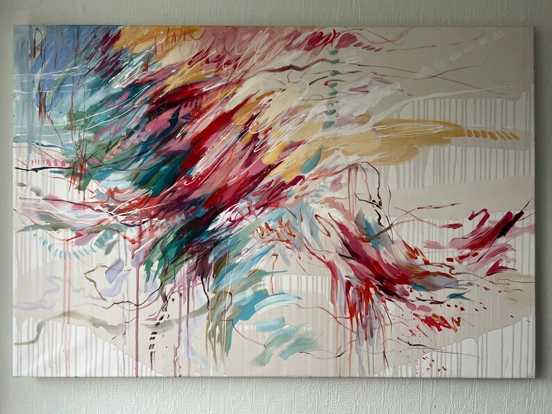May include: Abstract painting on canvas with a beige background. The artwork features dynamic brushstrokes in shades of red, teal, yellow, and white, creating a sense of movement. Vertical white lines and drips add texture to the piece.