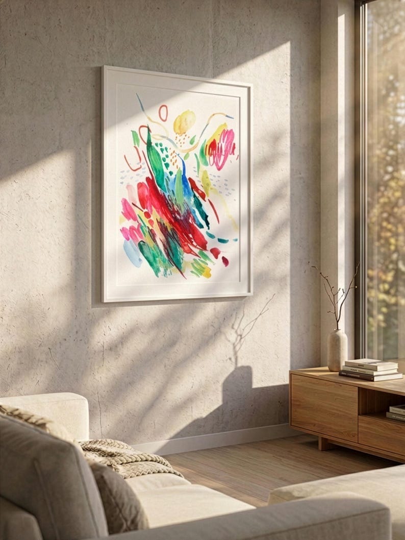 May include: A framed abstract wall art print featuring vibrant, expressive brushstrokes in shades of red, yellow, green, and blue on a white background. The artwork is displayed in a simple white frame, showcasing dynamic, gestural marks and colorful shapes.