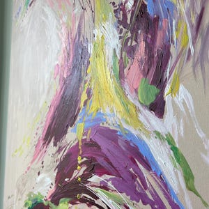May include: Abstract painting with a beige background and bold brushstrokes in shades of purple, yellow, pink, blue, and white. The artwork features a textured, expressive style with visible paint marks and drips, creating a dynamic visual effect.