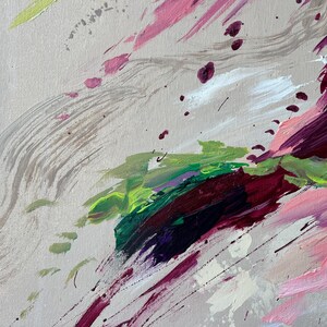 May include: Abstract painting with a neutral background and bold brushstrokes in shades of pink, green, purple, and white. The artwork features a mix of splatters and sweeping lines, creating a dynamic and textured composition.
