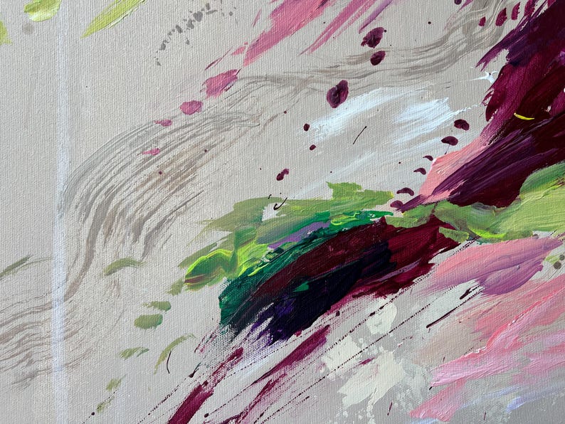 May include: Abstract painting with a neutral background and bold brushstrokes in shades of pink, green, purple, and white. The artwork features a mix of splatters and sweeping lines, creating a dynamic and textured composition.