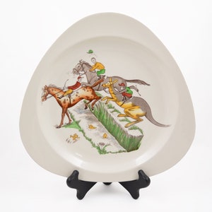 May include: A set of three ceramic mugs with a speckled, cream-colored glaze. Each mug features a different hand-painted design: a blue and green leaf, a yellow flower, and a red berry. The mugs have a simple, modern design.