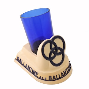 May include: A set of three ceramic nesting bowls in graduating sizes. The bowls are white with a speckled, textured finish and feature a slightly flared rim. The largest bowl measures approximately 8 inches in diameter.