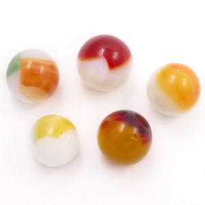May include: Five colorful marbles with a glossy finish are arranged against a white background. The marbles feature a mix of colors, including red, orange, yellow, and green, with white accents. These vintage marbles are perfect for collectors.