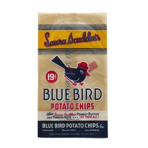 May include: A vintage bag of Blue Bird Potato Chips. The bag features a cartoon bluebird wearing a red hat and holding a snack. The text on the bag includes "Laura Scudder's" and "Blue Bird Potato Chips". The bag is tan with blue and yellow accents.