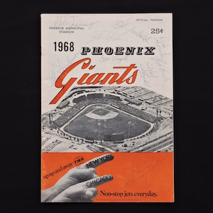 May include: A vintage 1968 Phoenix Giants baseball program. The cover features a stadium illustration in black and white, with the team name in orange. Includes signatures and text: "up up and away" and "Non-stop jets everyday."