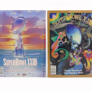 May include: Two vintage Super Bowl game programs. The first features the Super Bowl XXIII trophy against a sunset backdrop. The second program is for Super Bowl XXIV, with colorful illustrations and the teams Denver Broncos vs. San Francisco 49ers.