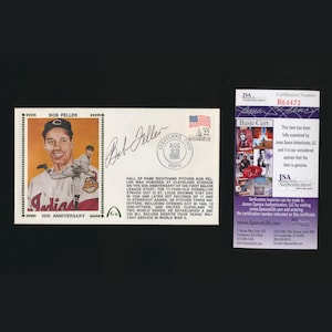 May include: A commemorative envelope featuring a portrait of Bob Feller, a Hall of Fame right-handed pitcher. The envelope includes a stamp, a signature, and a Cleveland, Ohio postmark from 1986. A certificate of authenticity is also included.
