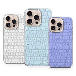 May include: Three phone cases with keyboard designs. The cases are white, light blue, and purple. Each case has a camera cutout and a keyboard layout printed on the back, including letters, numbers, and symbols.