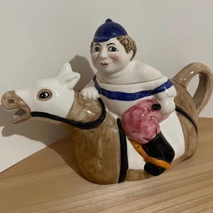 Vintage Horse and Plump Jockey Teapot. Porcelain. Made in Taiwan. 1990. 11” Wide  7” Tall 5” Deep. Pompom on hat has a chip and chipped tail