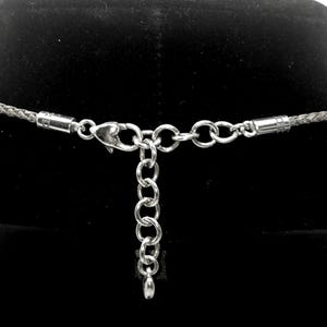 “Designed with an extender chain so you can wear it close to the neckline or a little longer.”