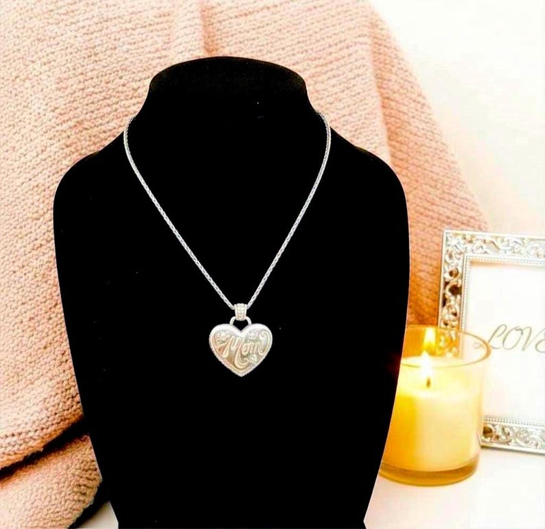 A sweet tribute to the many hats we wear. Engraved with ten roles, this heart pendant makes a thoughtful everyday keepsake.