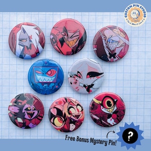 May include: A collection of eight round pinback buttons featuring colorful cartoon character designs. The buttons showcase various characters in red, blue, and white, with the text "Free Bonus Mystery Pin!" at the bottom. The Custom Pin Studio logo is in the top right corner.