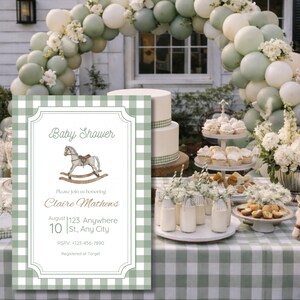 May include: A baby shower scene with a green and white checked tablecloth. The table is set with a cake, cupcakes, and a sign saying "Baby Shower". A balloon arch and a toy rocking horse are also visible. The invitation includes the text.