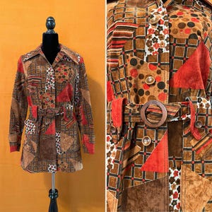 May include: A brown, red, and white patchwork suede jacket with a brown belt. The jacket has a button-up front and long sleeves.